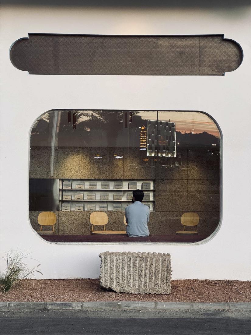 Camel Step seen from the street at dusk through the rounded window, bean shelves inside